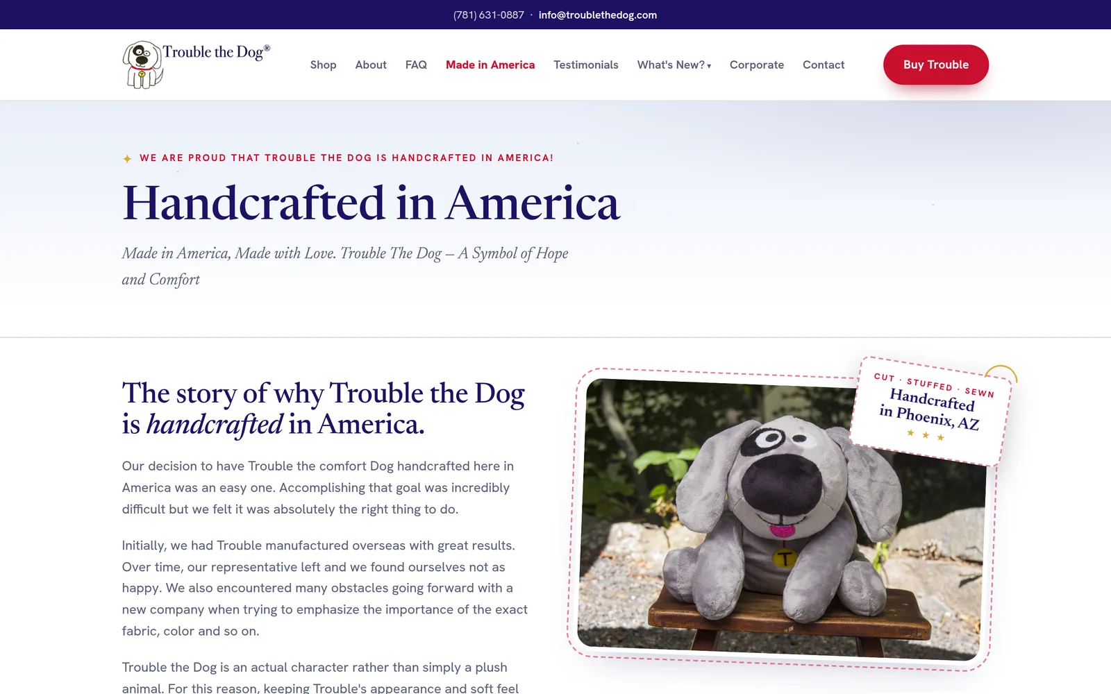 A page from the rebuilt Trouble the Dog site: a clear menu with a red Buy Trouble button, the large serif heading Handcrafted in America, and a photo of the plush dog sitting on a small wooden stool.
